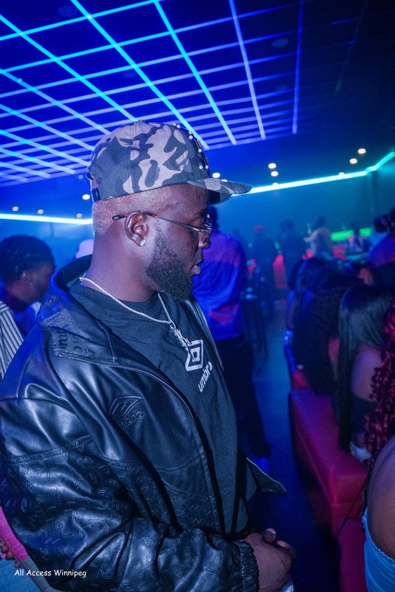 Headliner standing in the crowd under the club's blue laser ceiling, ROCAFIESTA